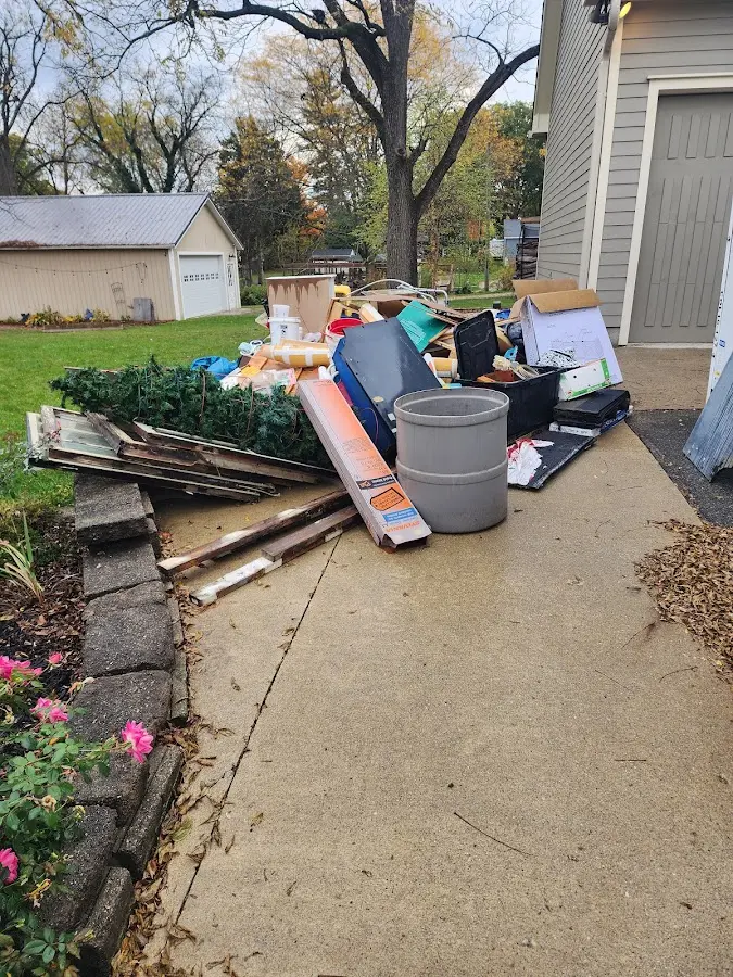 Dumpster being loaded with debris for Roofing Dumpster Rental in Washington